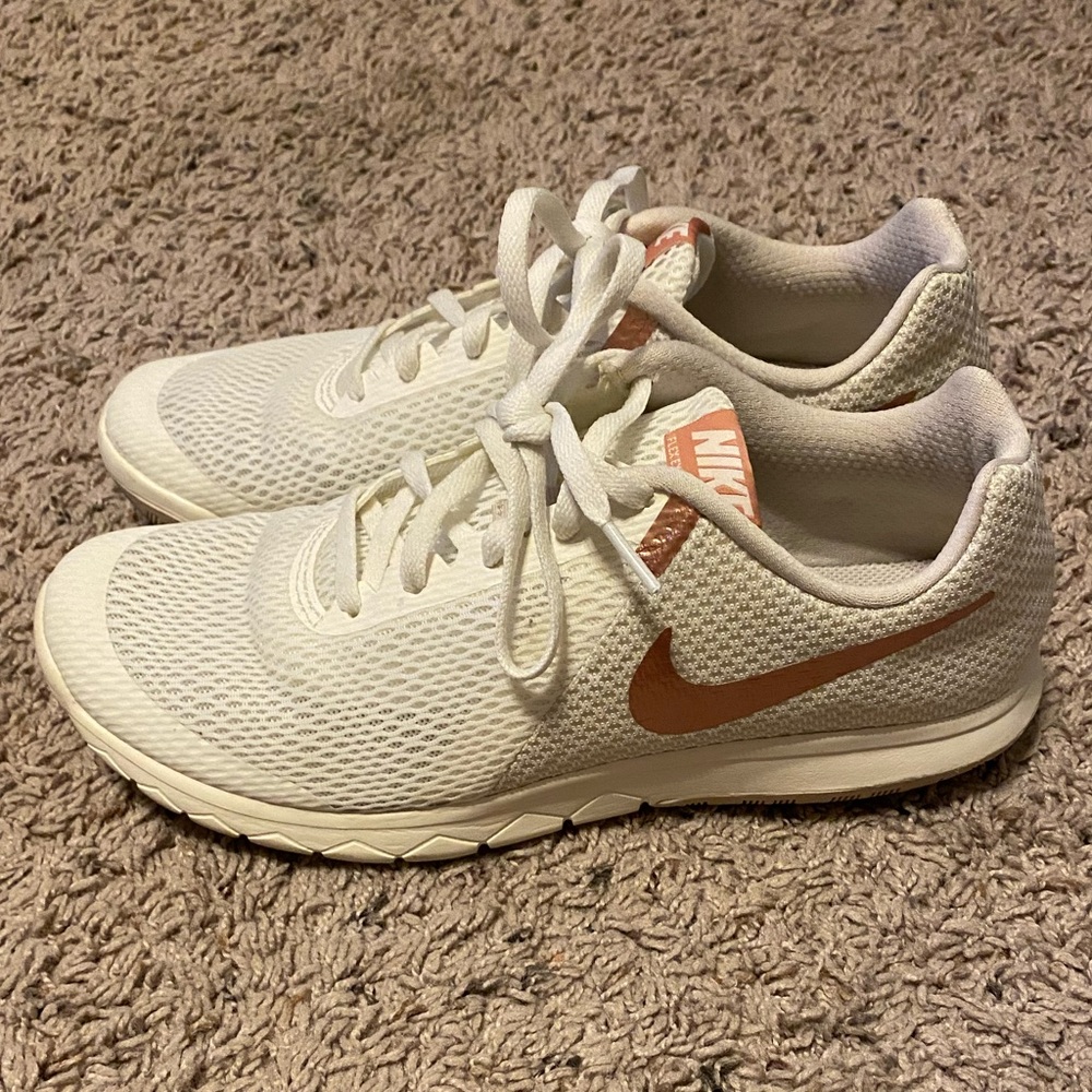 Women’s white and rose gold Nike shoes